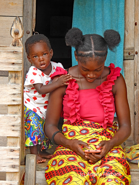 young woman and child framed in hut