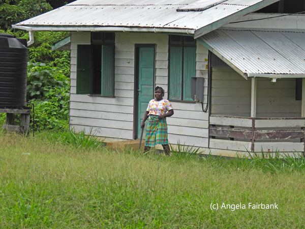 woman with machete outside house
