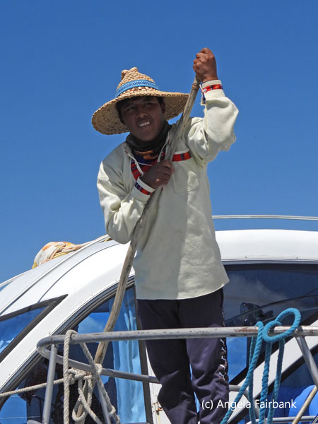 man with pole on boat