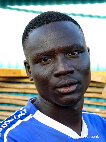 Toposa youth in blue shirt at market
