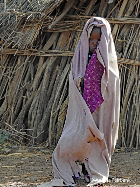 Toposa child in blanket