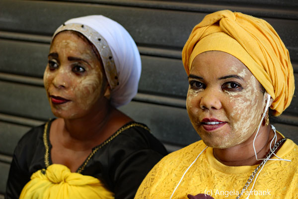 two women in yellow at the market