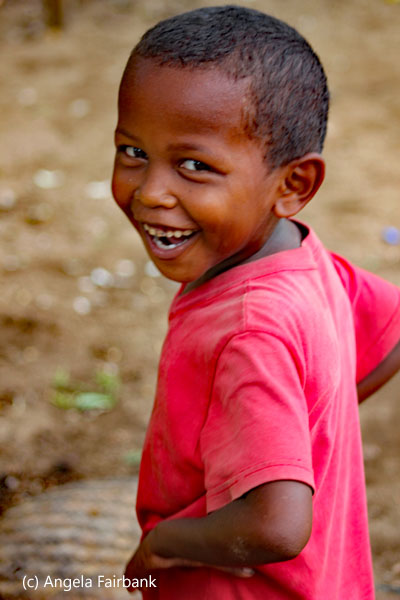 boy in pink shirt smiling