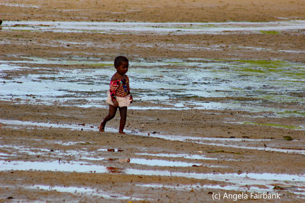 child walking across beach