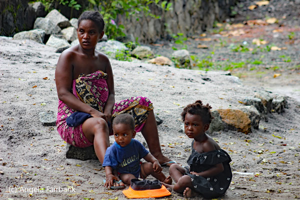 woman sitting with 2 children