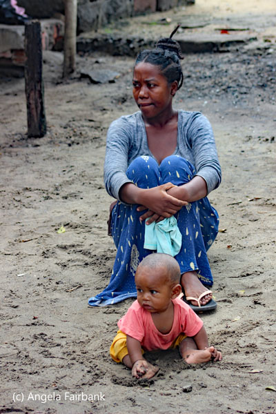 woman in blue with baby