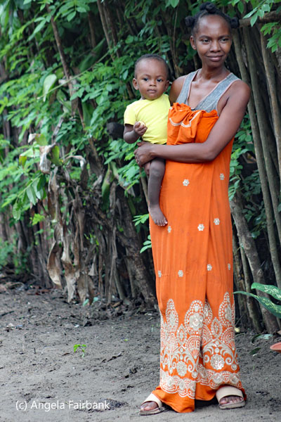 woman in orange with baby