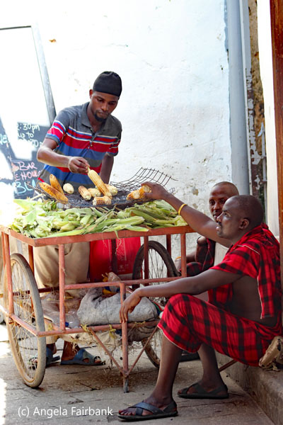 maasai with corm vendor