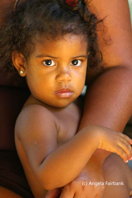 girl sitting on mother lap