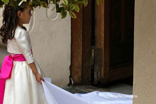 girl holding bridal train
