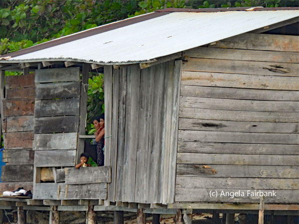 family in hut on stilts 1