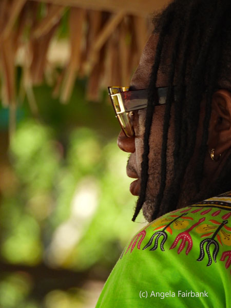 singer in green and glasses