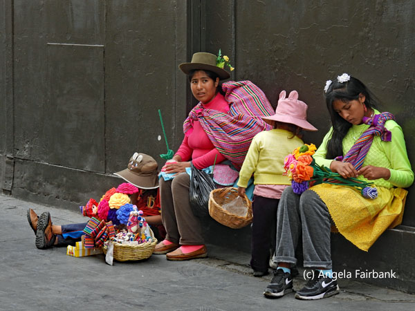 cusco family sitting on street