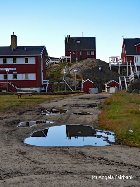 reflecting houses in puddle 
