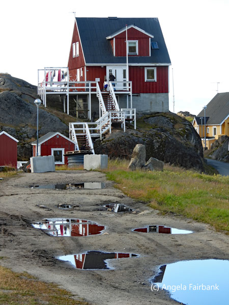 building reflecting in puddles